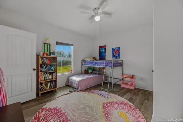 a bedroom with bed and a book shelf