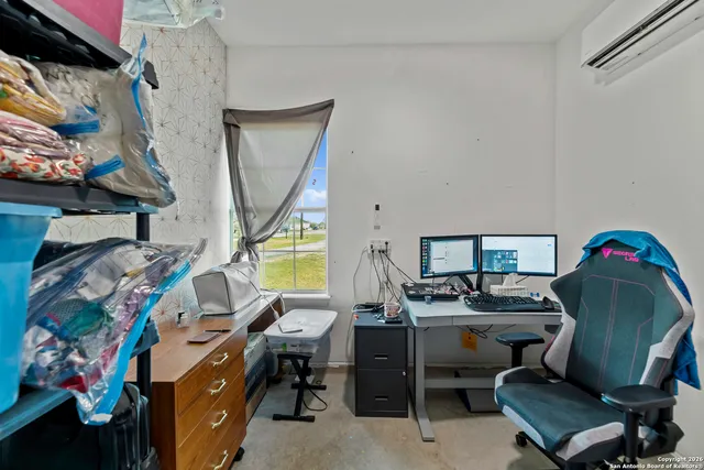 a view of a workspace with furniture and storage