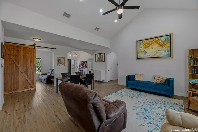 a living room with furniture and wooden floor