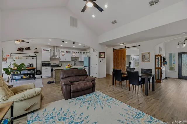 a living room with furniture and wooden floor