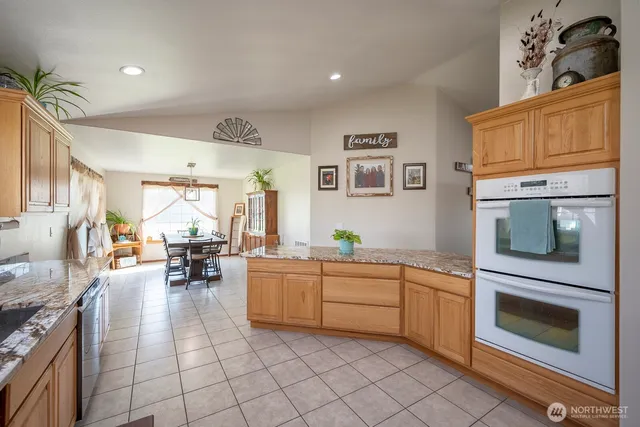 a kitchen with stainless steel appliances a stove a sink and a refrigerator