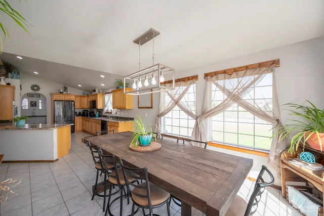 a view of a dining room with furniture and a window