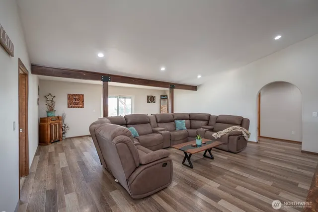a living room with furniture and a wooden floor