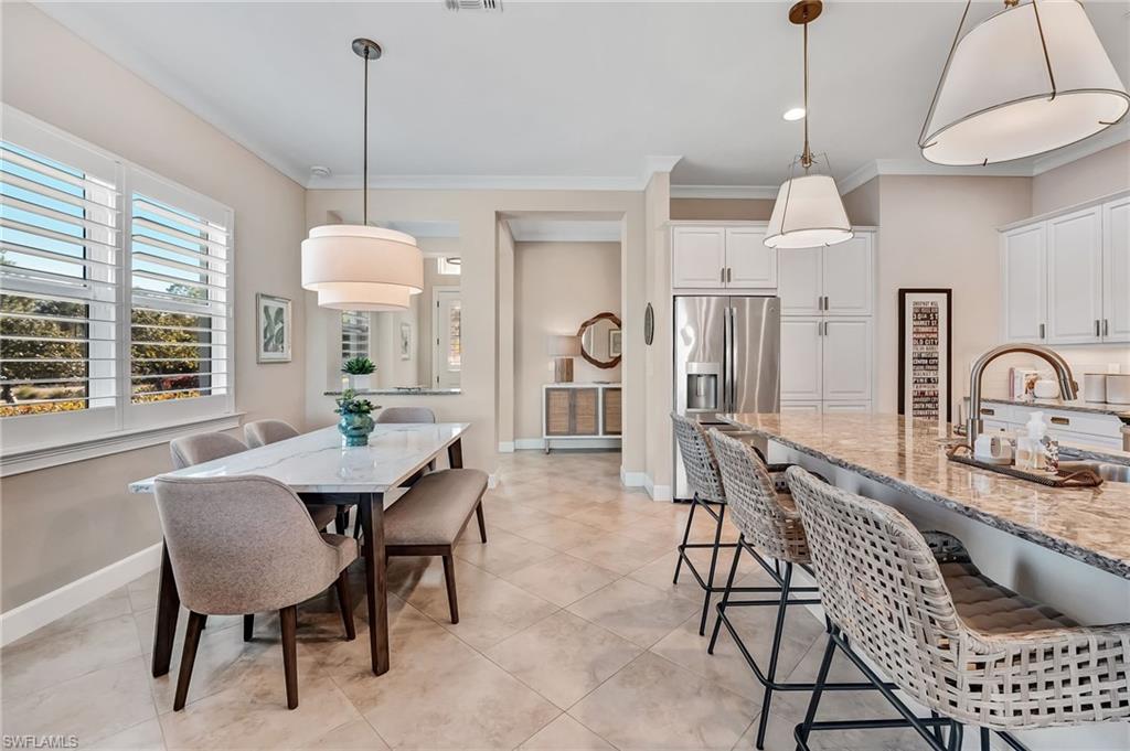 7002 Dominica Drive Naples, FL 34113 - Photo 16 of 45 Dining area featuring crown molding and light tile patterned flooring