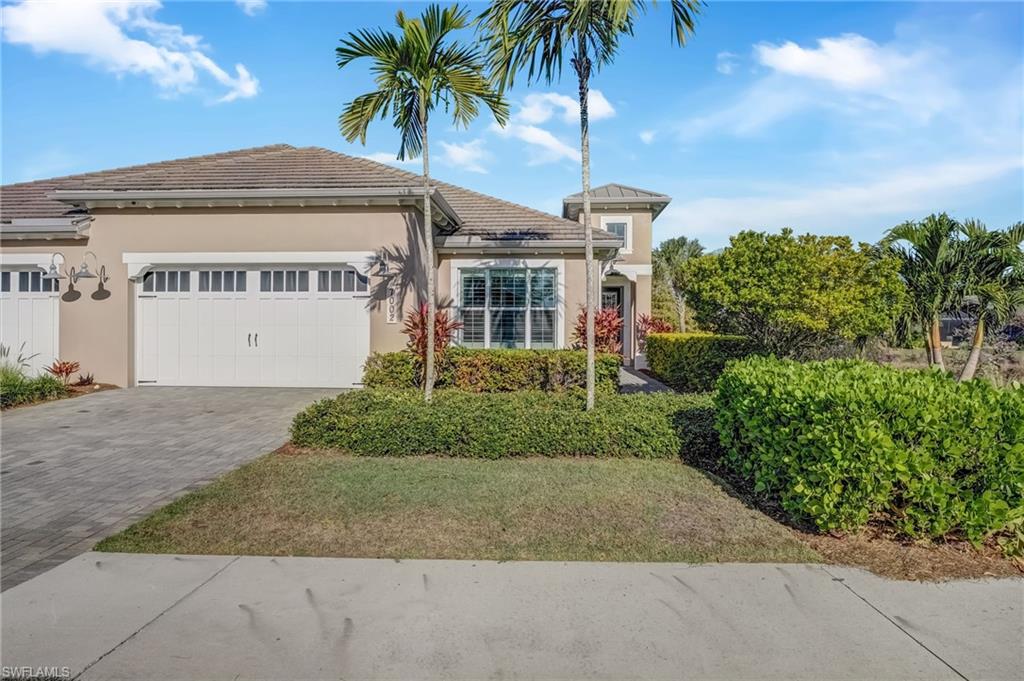 7002 Dominica Drive Naples, FL 34113 - Photo 2 of 45 View of front of home with stucco siding, decorative driveway, a garage, and a tiled roof