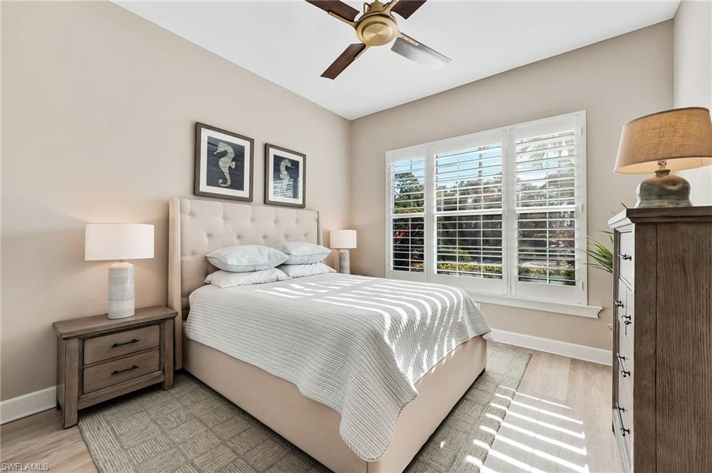 7002 Dominica Drive Naples, FL 34113 - Photo 29 of 45 Bedroom with a ceiling fan and light wood-style flooring