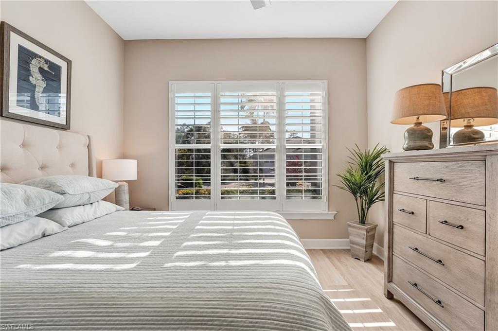 7002 Dominica Drive Naples, FL 34113 - Photo 30 of 45 Bedroom featuring light wood-type flooring and a ceiling fan