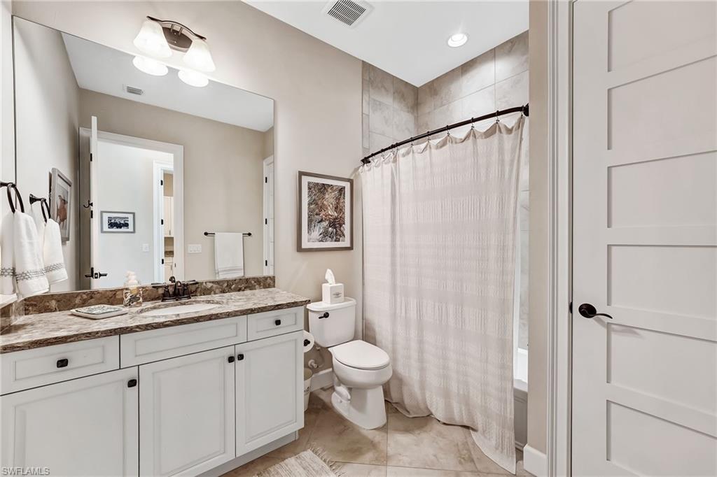 7002 Dominica Drive Naples, FL 34113 - Photo 32 of 45 Bathroom with vanity and light tile patterned floors