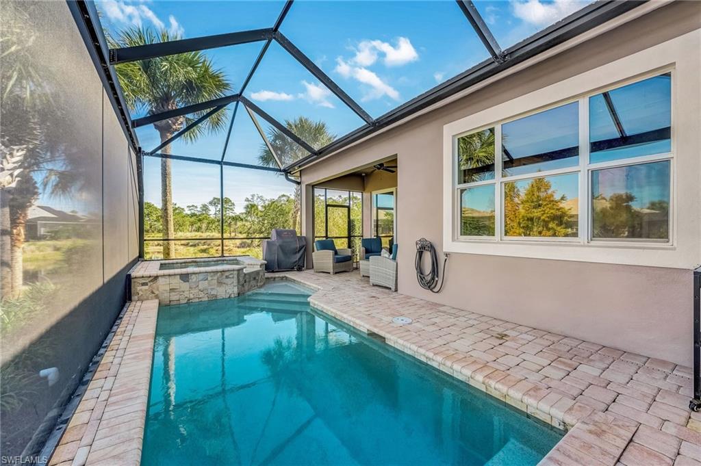 7002 Dominica Drive Naples, FL 34113 - Photo 39 of 45 View of pool with a sunroom, a patio area, and glass enclosure