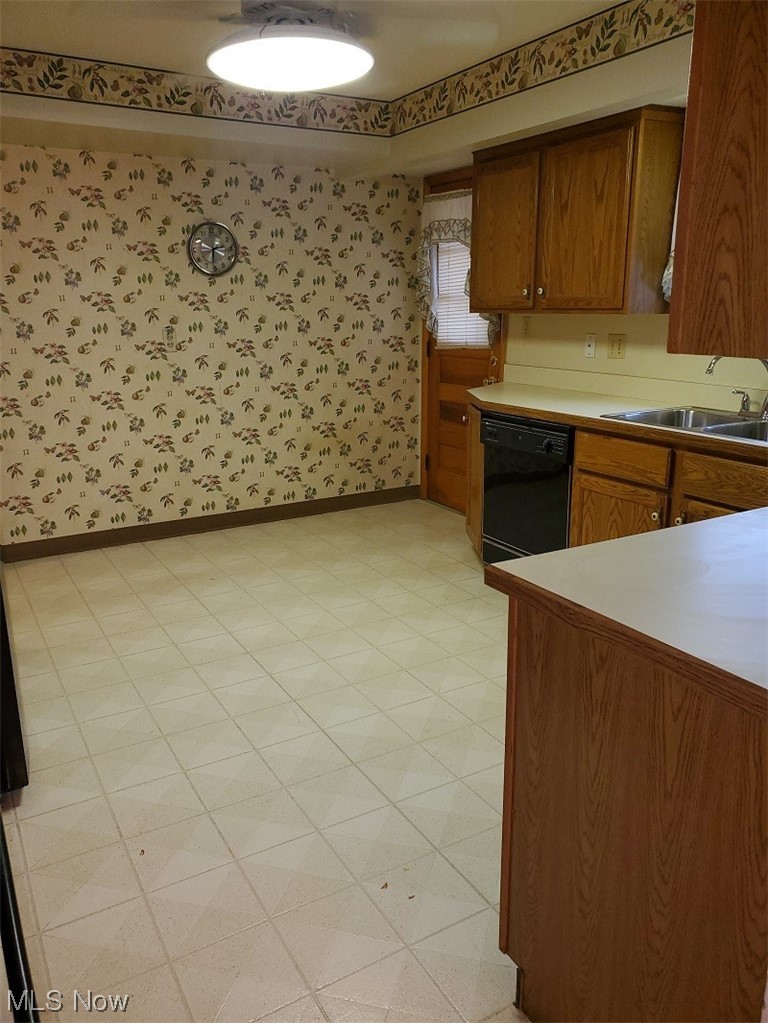 932 Pinecrest Road Girard, OH 44420 - Photo 18 of 25 Kitchen with black dishwasher, sink, and light tile floors
