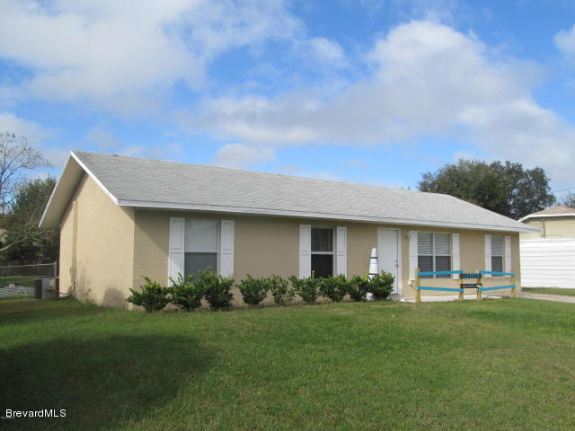 a front view of a house with a garden and yard