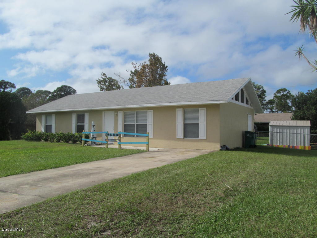 7000 Bryant Road Cocoa, FL 32927 - Photo 2 of 13 front view of a house with a garden