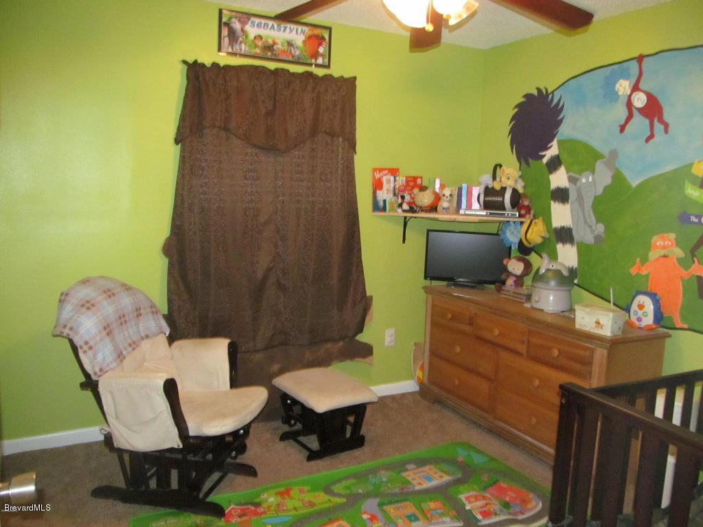 7000 Bryant Road Cocoa, FL 32927 - Photo 11 of 13 a room with a chair and a table