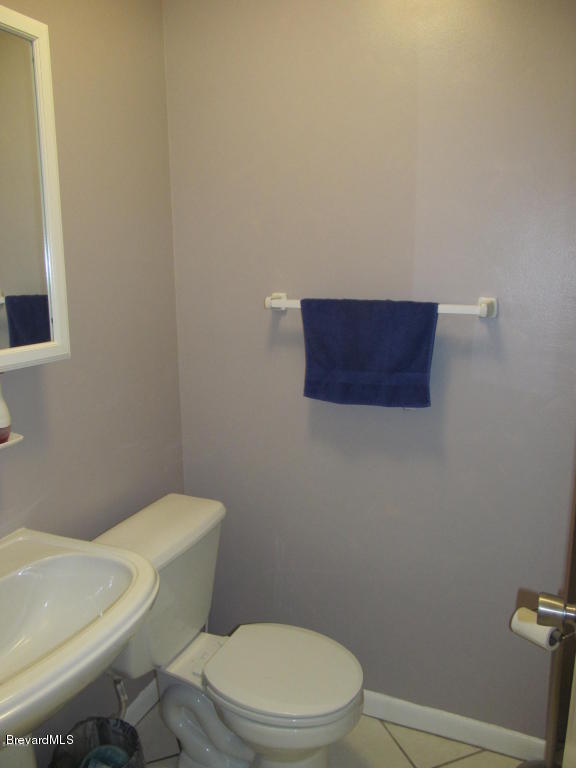 7000 Bryant Road Cocoa, FL 32927 - Photo 12 of 13 a white toilet sitting next to a white wall