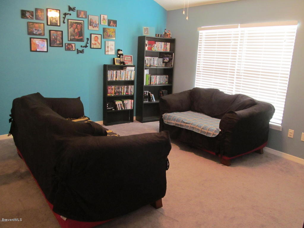 7000 Bryant Road Cocoa, FL 32927 - Photo 3 of 13 a living room with furniture and a window