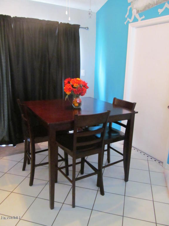 7000 Bryant Road Cocoa, FL 32927 - Photo 4 of 13 a dining room table with chairs and window
