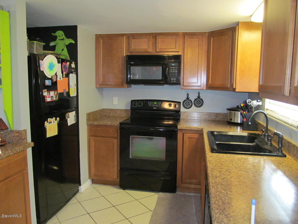 7000 Bryant Road Cocoa, FL 32927 - Photo 6 of 13 a kitchen with a sink and a stove top oven