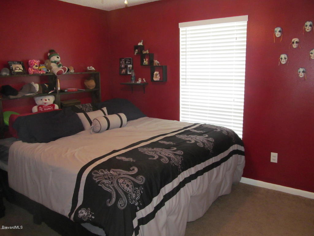 7000 Bryant Road Cocoa, FL 32927 - Photo 8 of 13 a bedroom with a bed and a window