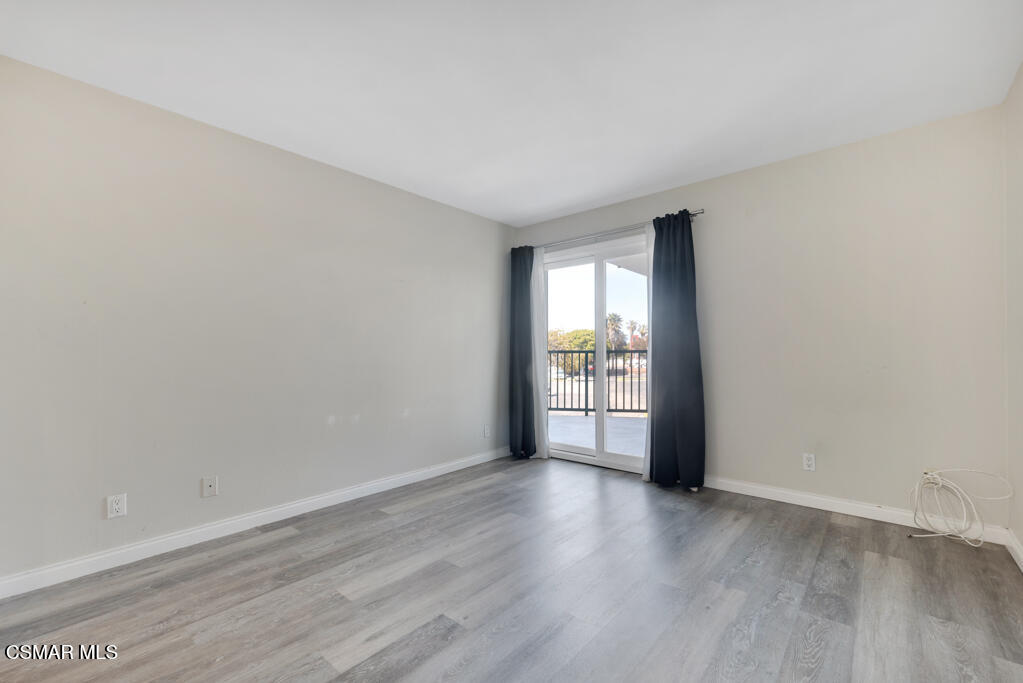 2901 Peninsula Road, Unit 137 Oxnard, CA 93035 - Photo 12 of 35 wooden floor in an empty room with a window