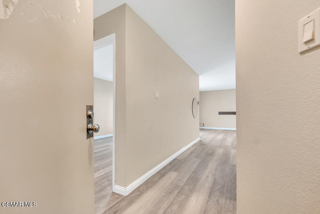 2901 Peninsula Road, Unit 137 Oxnard, CA 93035 - Photo 3 of 35 a view of a hallway with wooden floor