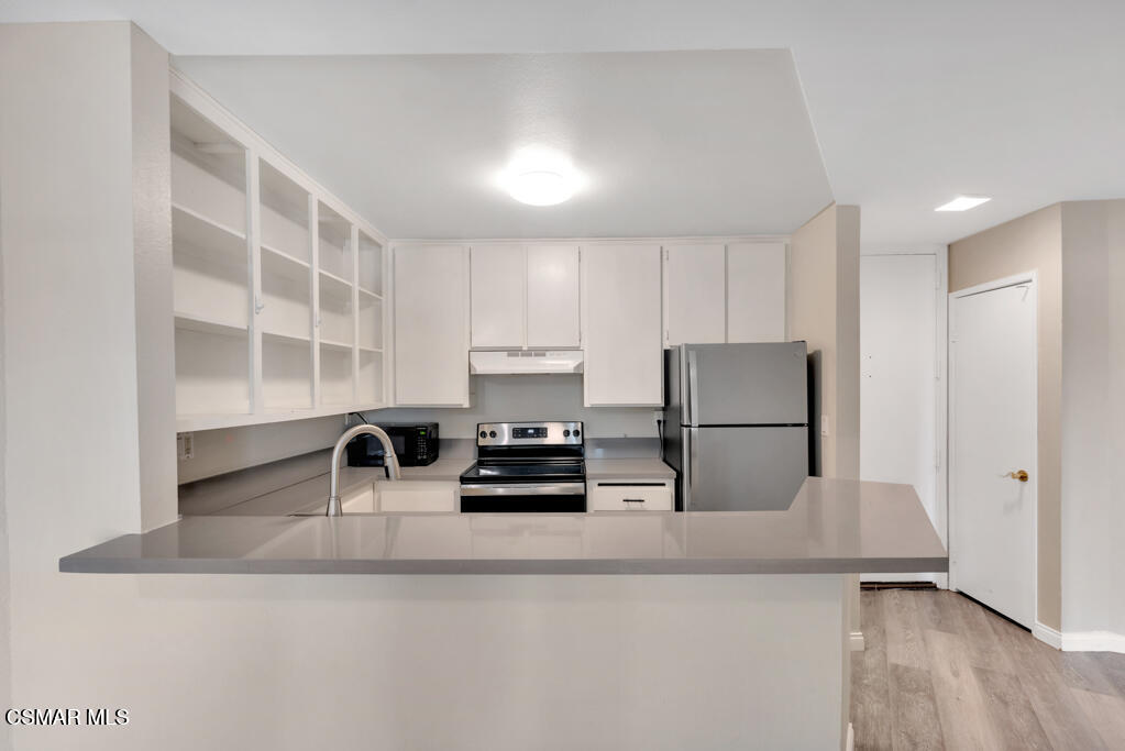 2901 Peninsula Road, Unit 137 Oxnard, CA 93035 - Photo 7 of 35 a kitchen with stainless steel appliances a refrigerator and a sink