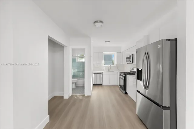 a kitchen with a refrigerator and a sink
