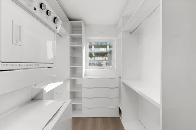 a view of walk in closet with empty racks