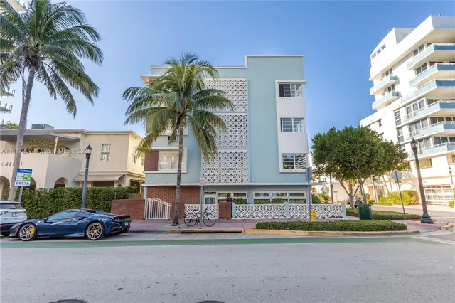 a car parked in front of a building with palm trees