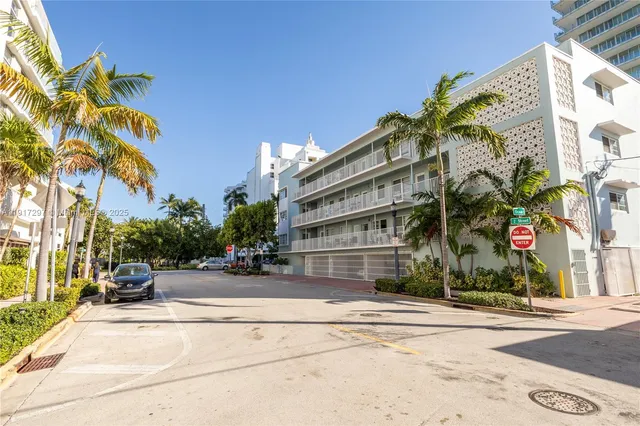 a front view of a house with a yard and a garage