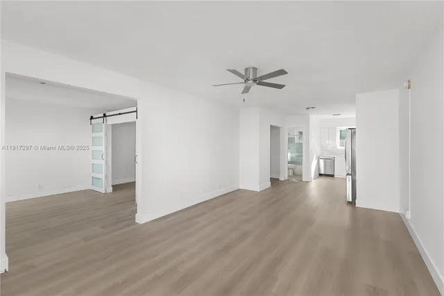 a view of a big room with wooden floor and a ceiling fan