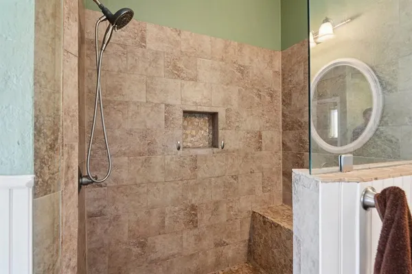a bathroom with a sink a vanity and a shower