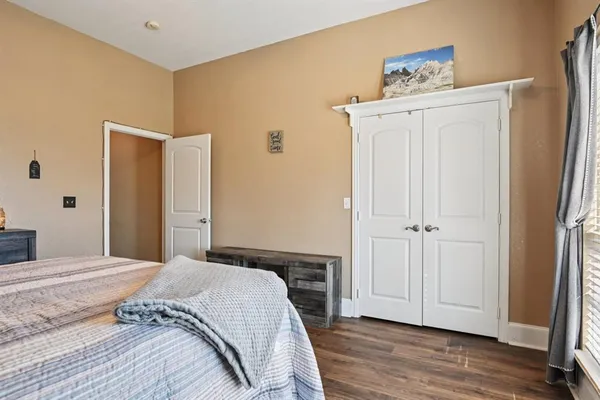 a bedroom with a bed and a mirror