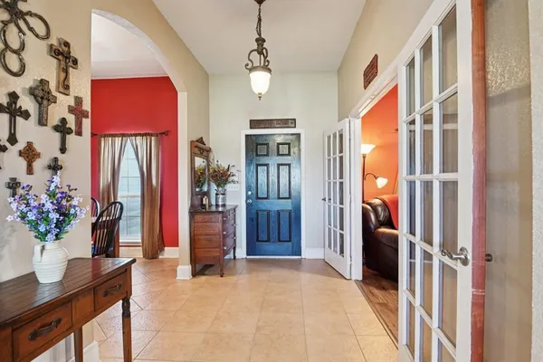 a view of an entryway with a flower pot and a bookshelf