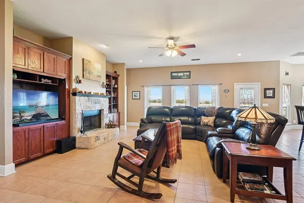 a living room with furniture a fireplace and a flat screen tv