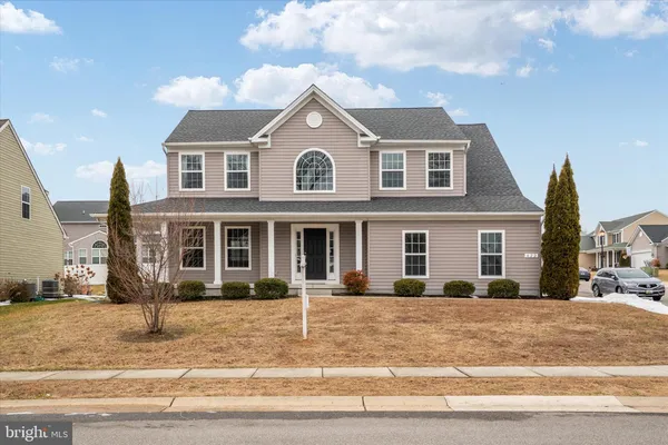 a view of a brick house with a clock tower in middle of it