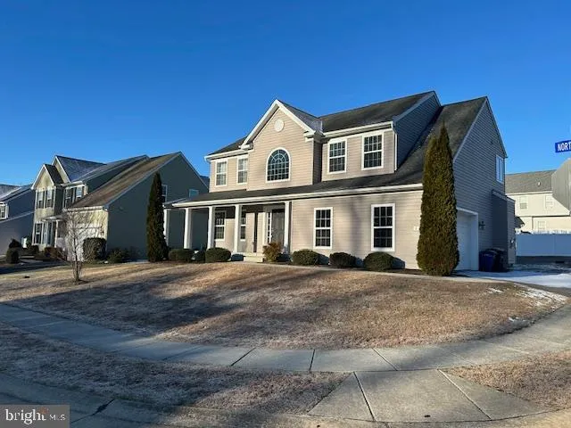 a view of a white house with a large windows in front of it