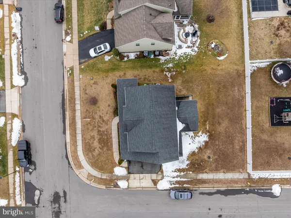 an aerial view of a residential building with parking space