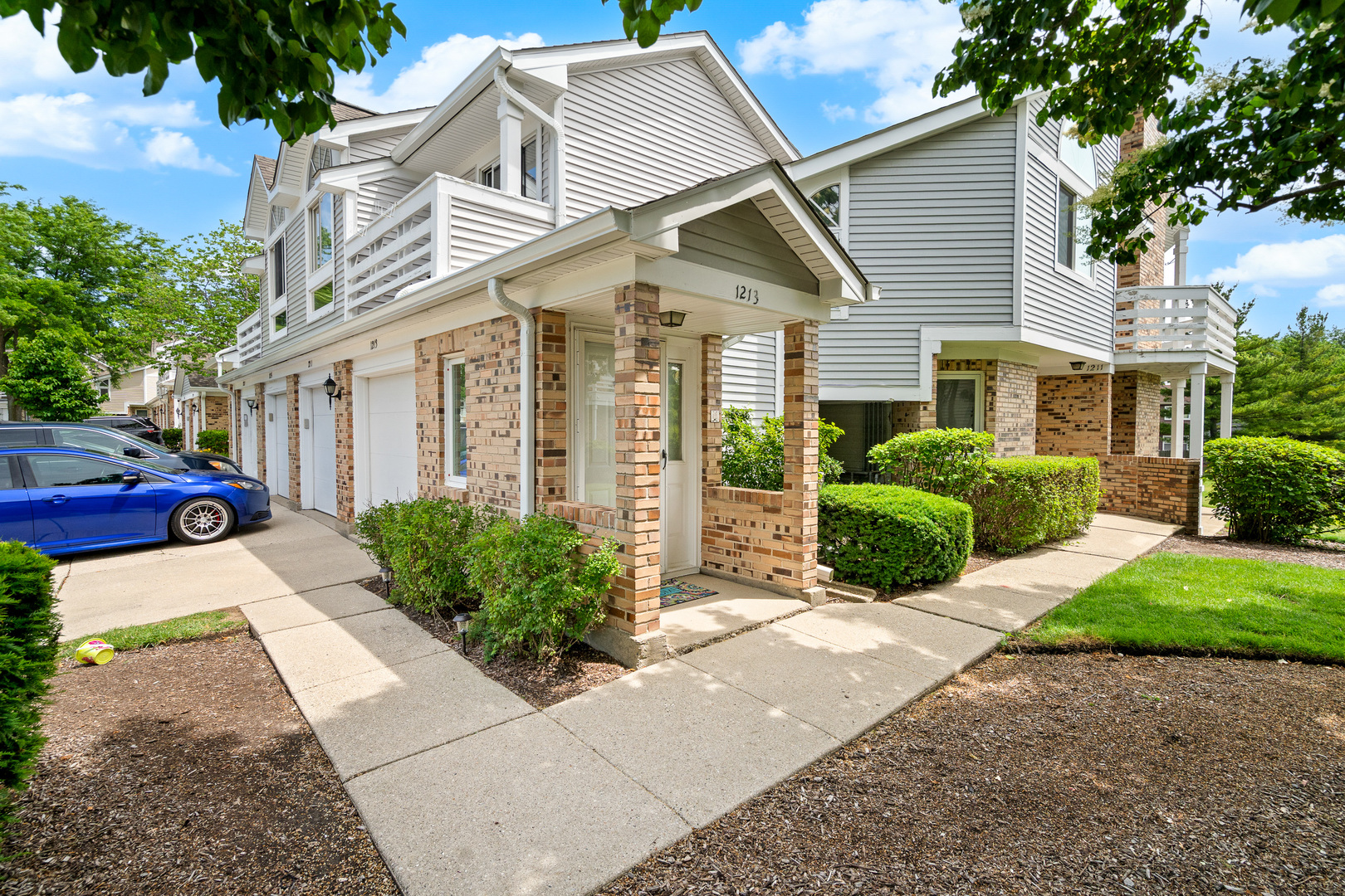 1213 Ranchview Court Buffalo Grove, IL 60089 - Photo 1 of 1 a view of a white house with a large windows plants and large tree