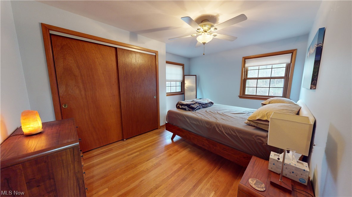 1243 Yellowstone Road Cleveland, OH 44121 - Photo 14 of 28 Bedroom with ceiling fan, light wood-type flooring, and a closet