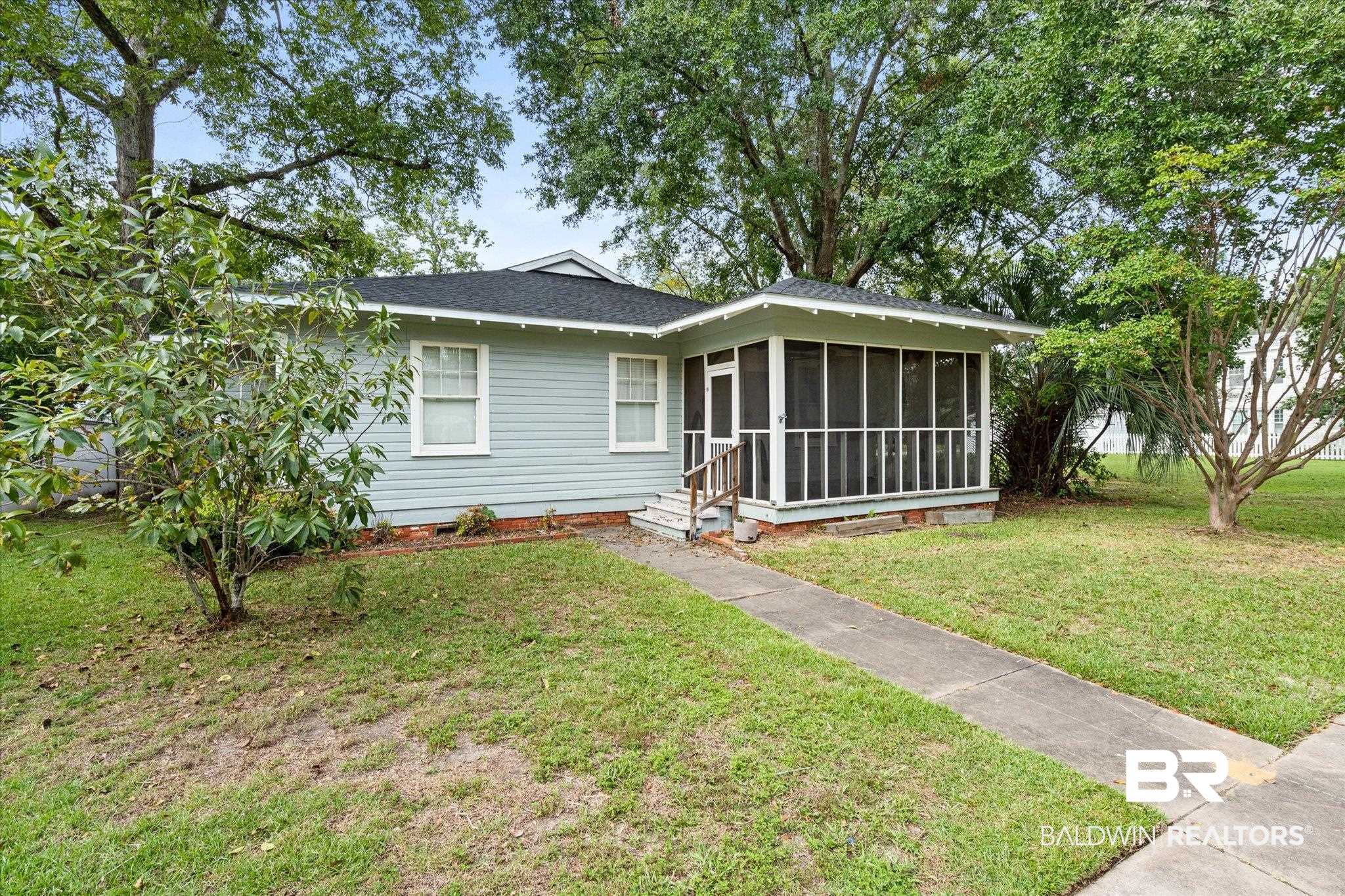211 3rd Street Mobile, AL 36611 - Photo 1 of 20 View of front of property with a sunroom and a front lawn