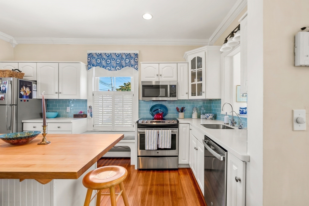 60 Gregory Street, Unit 3 Marblehead, MA 01945 - Photo 11 of 42 a kitchen with a stove and white cabinets