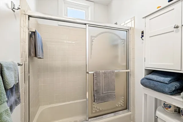 a bathroom with a shower and a mirror