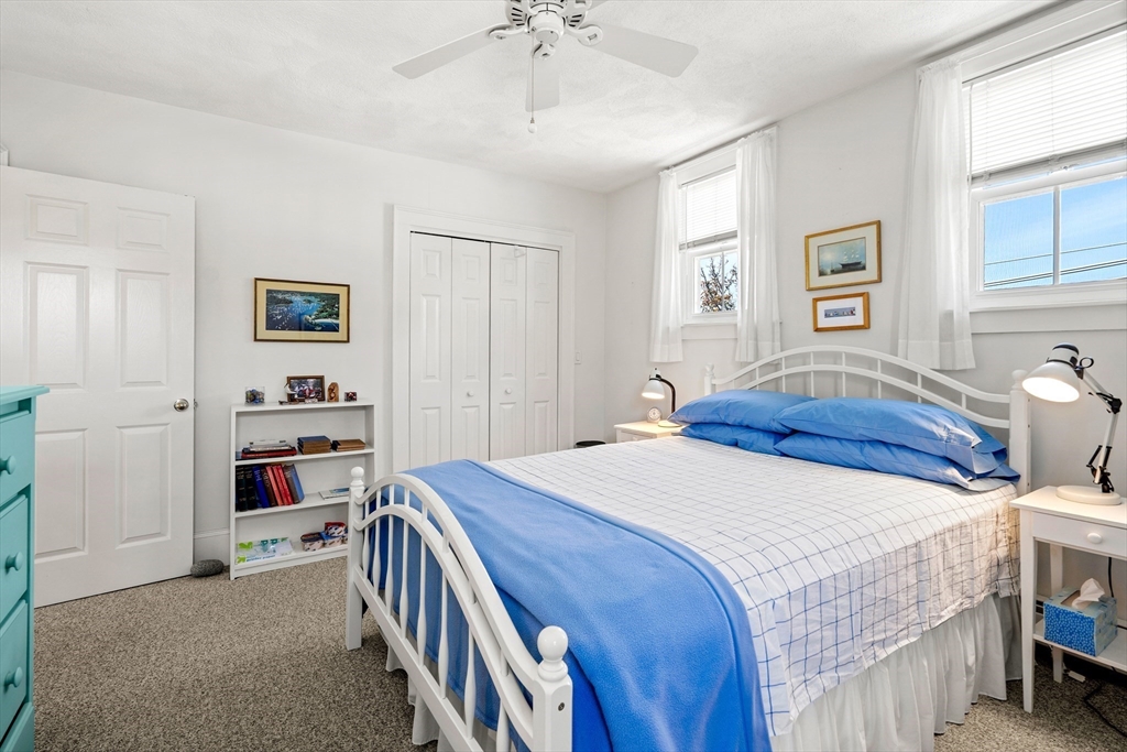60 Gregory Street, Unit 3 Marblehead, MA 01945 - Photo 41 of 42 a bedroom with a bed and a walk in closet