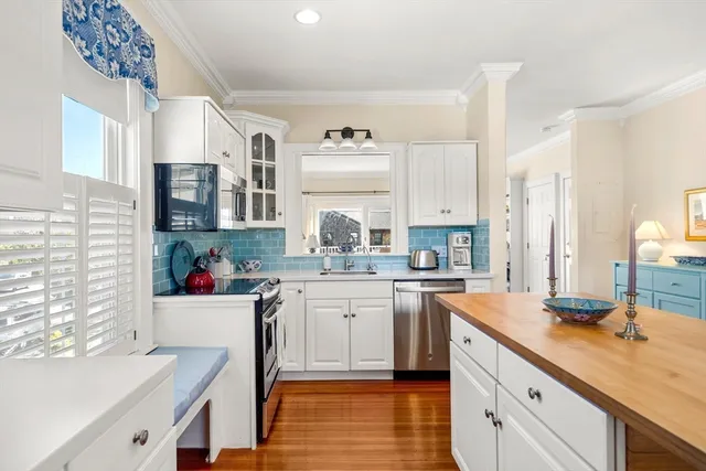 a kitchen with a sink stove and cabinets