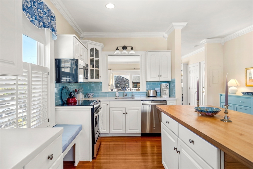 60 Gregory Street, Unit 3 Marblehead, MA 01945 - Photo 10 of 42 a kitchen with a sink stove and cabinets