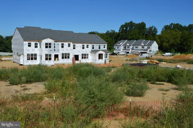 a view of a dry yard with a house
