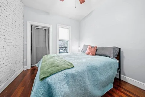 a bedroom with a bed and window