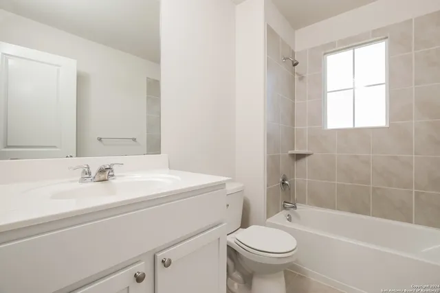 a bathroom with a sink a toilet and a bathtub