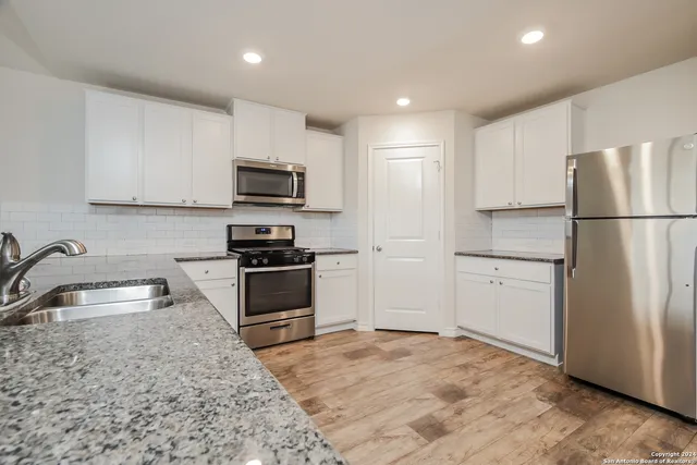 a kitchen with a refrigerator sink and microwave