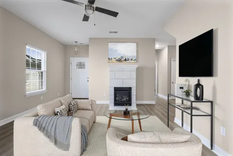 a living room with furniture and a flat screen tv